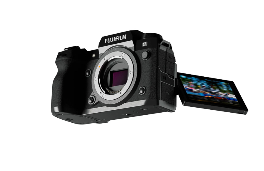 A Fujifilm camera with an open articulating screen displaying an image, viewed from a front angle.