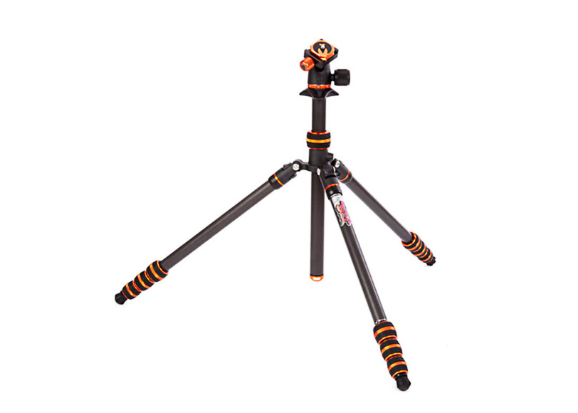 A black and orange camera tripod with collapsible legs and an adjustable mount.