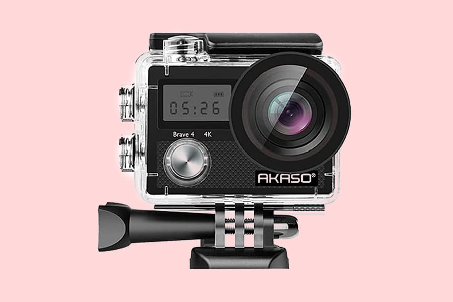 Akaso Brave 4 4K action camera mounted on a black clamp, displayed against a pink background.