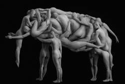 A monochrome sculpture depicts an array of intertwined, smooth, human-like figures forming an abstract, complex structure against a black background.