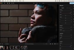 A person with short hair looks thoughtfully upward, wrapped in a fur scarf, with photo editing software interface visible on the screen.