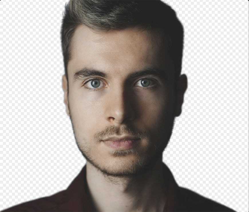 A person with short hair and a beard looks directly at the camera. The background is transparent.