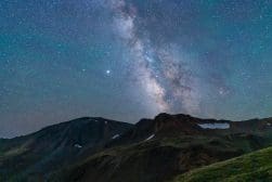The Milky Way galaxy visible over a mountain range under a clear night sky.