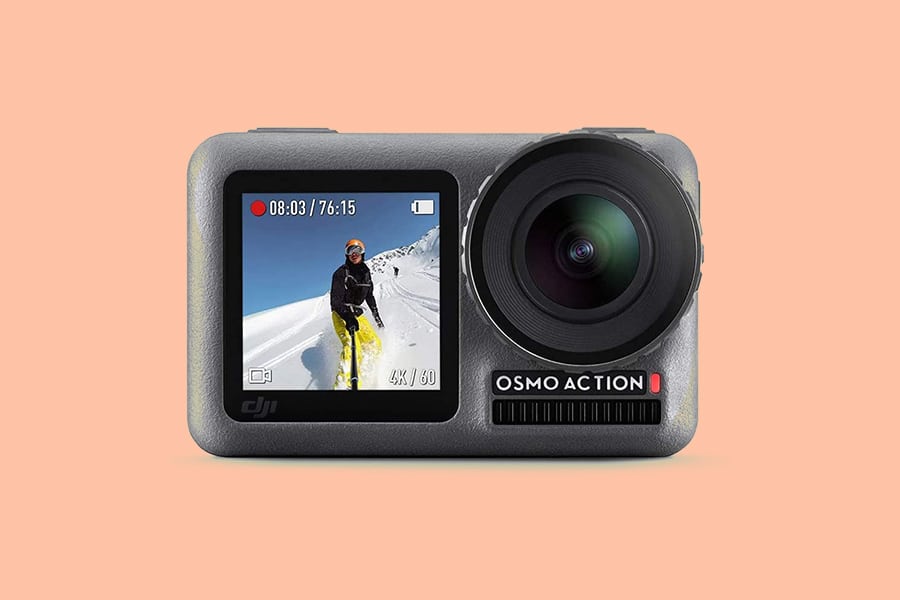 Compact action camera with a front LCD screen showing a skier on a snowy slope. The camera is branded "Osmo Action" and is set against a plain peach background.