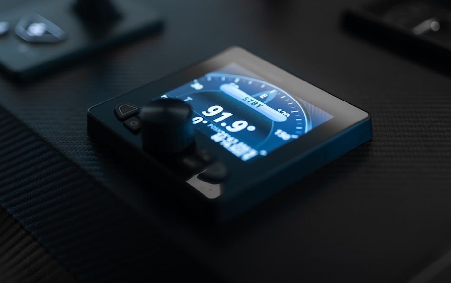 Close-up of a small digital display panel showing the temperature as 91.9 degrees, with a control knob next to it, on a dark surface.