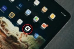 Close-up of a tablet screen displaying various app icons, with a focus on a red circle highlighting the "scada" app icon.