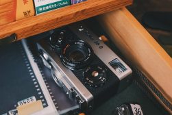 a camera sitting on top of a table next to a book.
