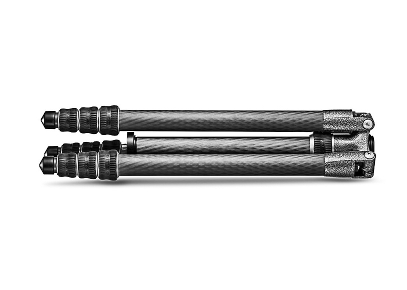 Folded carbon fiber tripod with textured finish and adjustable legs.