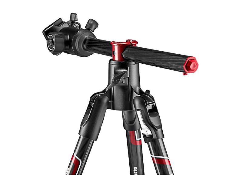 Close-up of a black and red tripod with adjustable legs and a swiveling head against a white background.