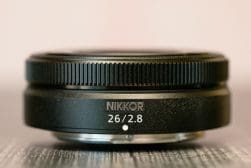 Close-up of a nikkor 26mm f/2.8 camera lens.