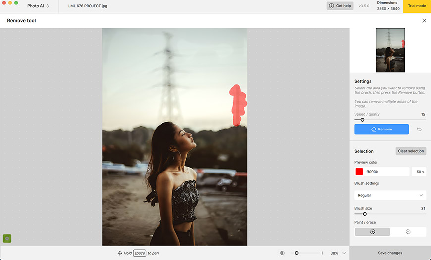 A person facing left outdoors, with a red object marked for removal in a photo editing program. Settings panel visible on the right.
