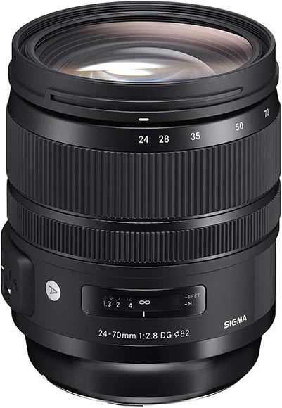 A Sigma 24-70mm f/2.8 DG lens for cameras, featuring a zoom ring, focus ring, distance scale, and lens mount visible. The lens is black with white markings indicating focal lengths and aperture.