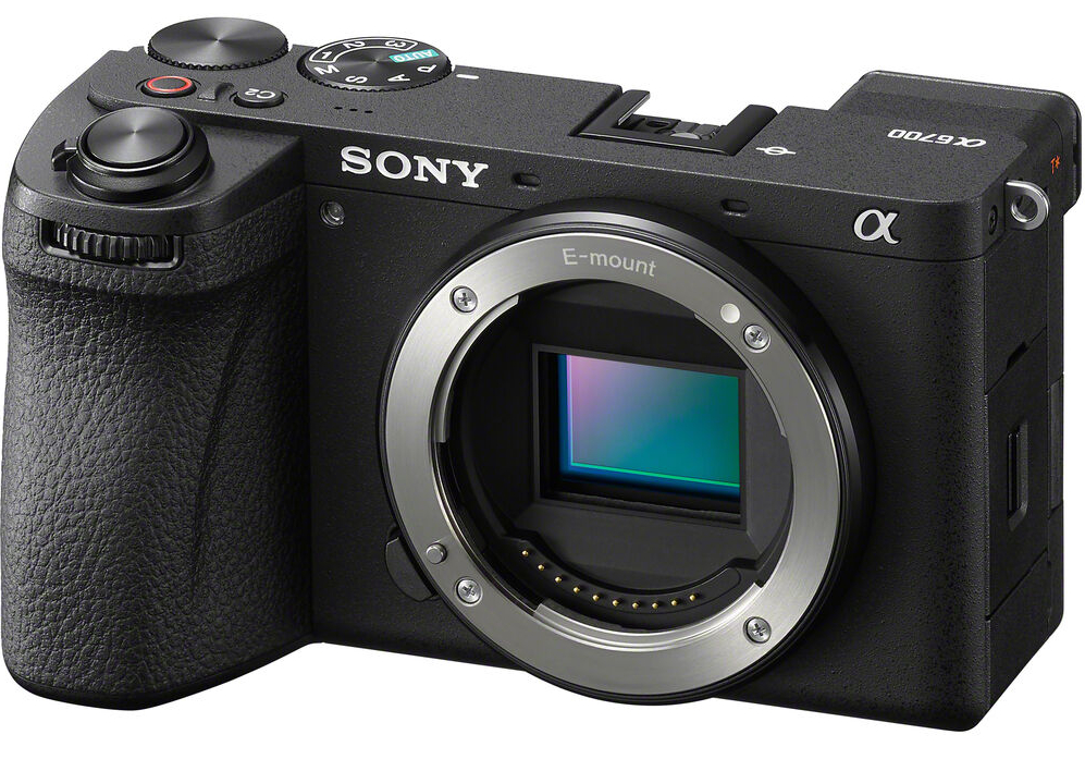 A Sony mirrorless camera with an E-mount and no lens attached, showing the sensor. The camera features a grip and several control dials.