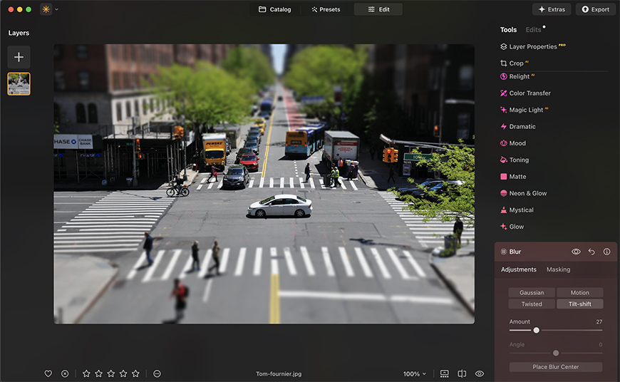 Photo editing software interface with a city street image in focus. Side panels display various editing tools and options.