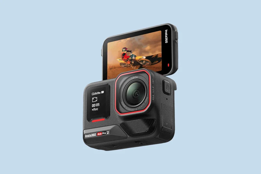 A modular action camera with two screens, displaying a motocross scene on the larger screen.